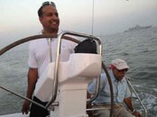 Sushil & I, at the helm of Peace & Plenty.jpg