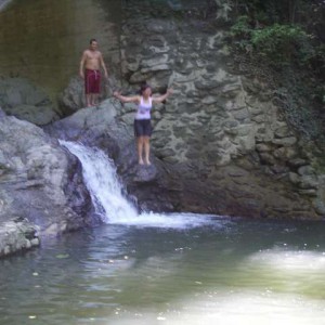 Iris jumping into waterfall pool