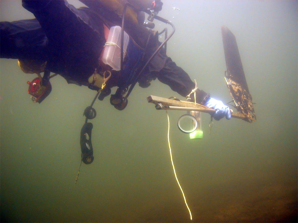 Dave carrying the newly found rudder/tiller. Freshwater dive at Dublin Lake