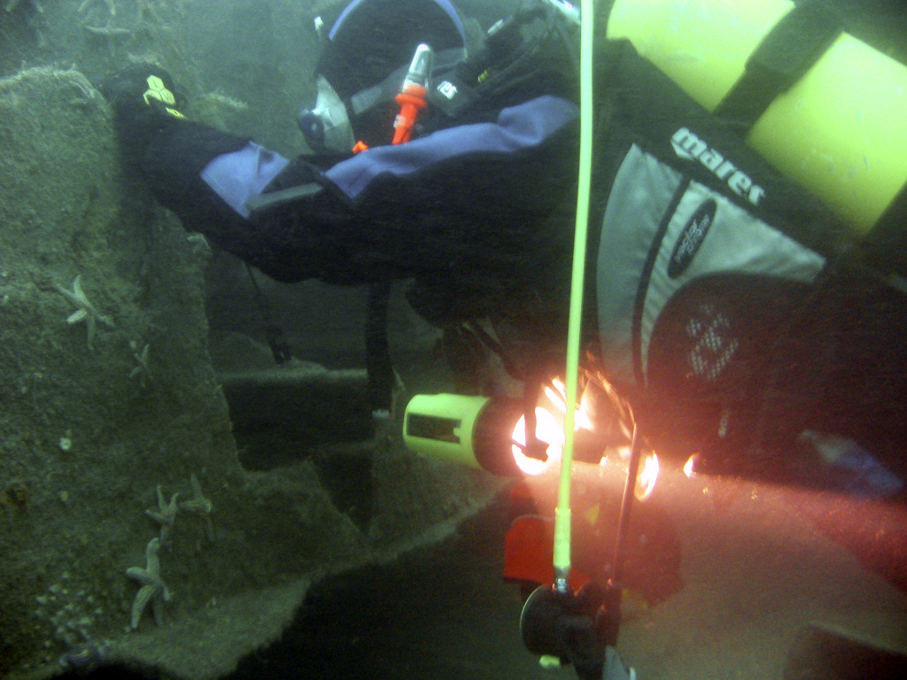 Diver examing a hole in the James Eagan Layne