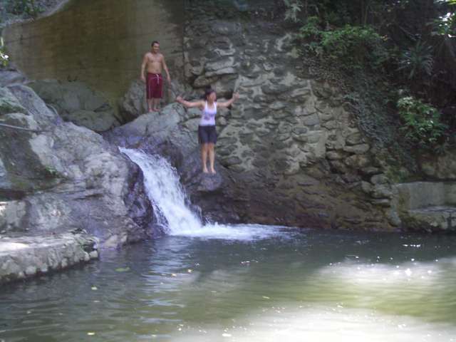 Iris jumping into waterfall pool