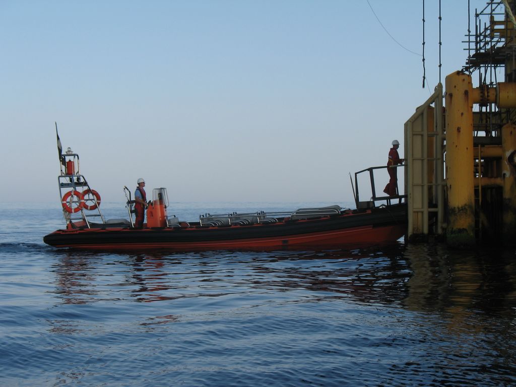 Rib 1 on a flat calm morning docks to transfer workers